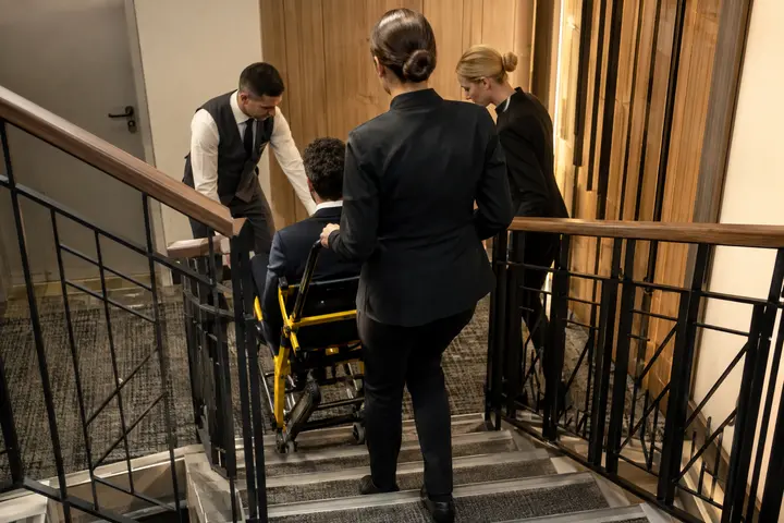 Emergency evacuation chair stored visibly near a hotel stair enclosure