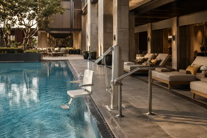 Hotel pool deck with installed accessibility lift and clear transfer area