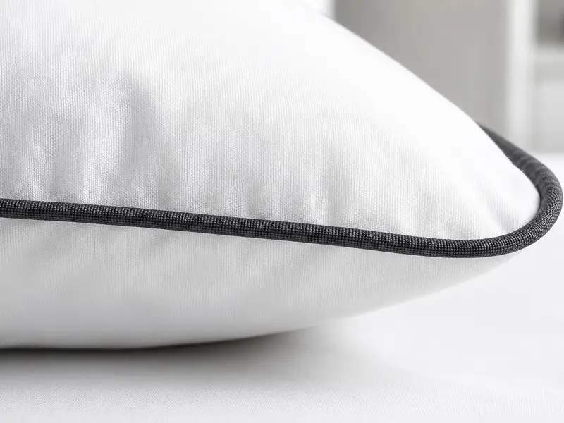 Tailored edge piping on hotel bedding