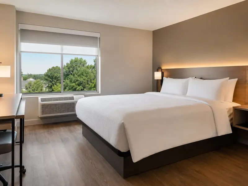 Value hotel room with durable easy-care bed linens