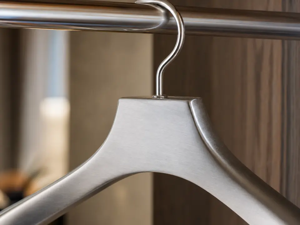 Brushed stainless hotel hanger material and hook detail