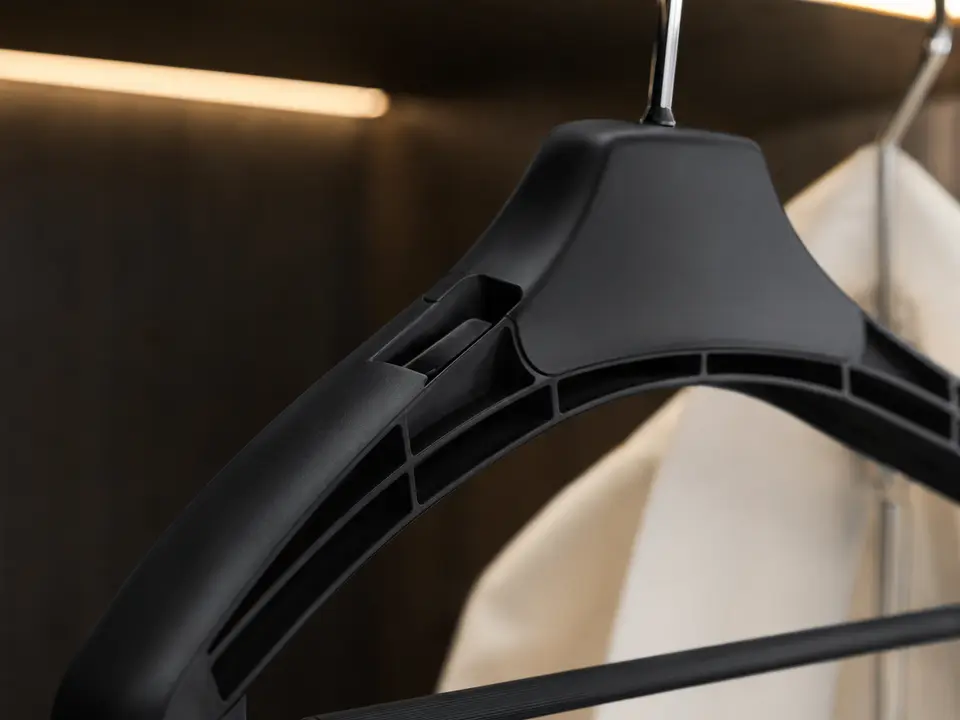 Durable molded hotel hanger polymer surface and reinforced shoulder