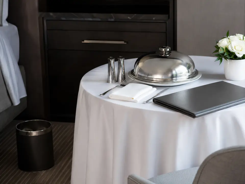 Room-service menu and dining setup in a hotel room