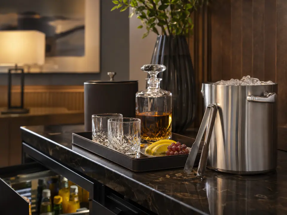 In-room refreshment setup with ice bucket and glassware