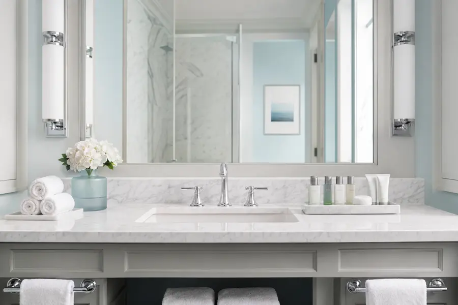 Guest bathroom vanity prepared with hotel toiletries