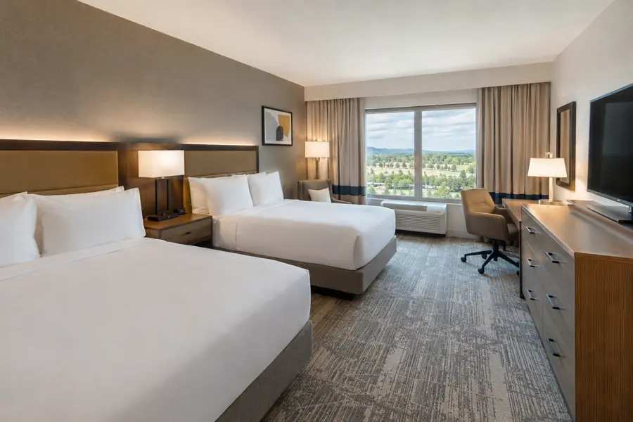 Renovated hotel guest room with new contract furniture and retained building conditions