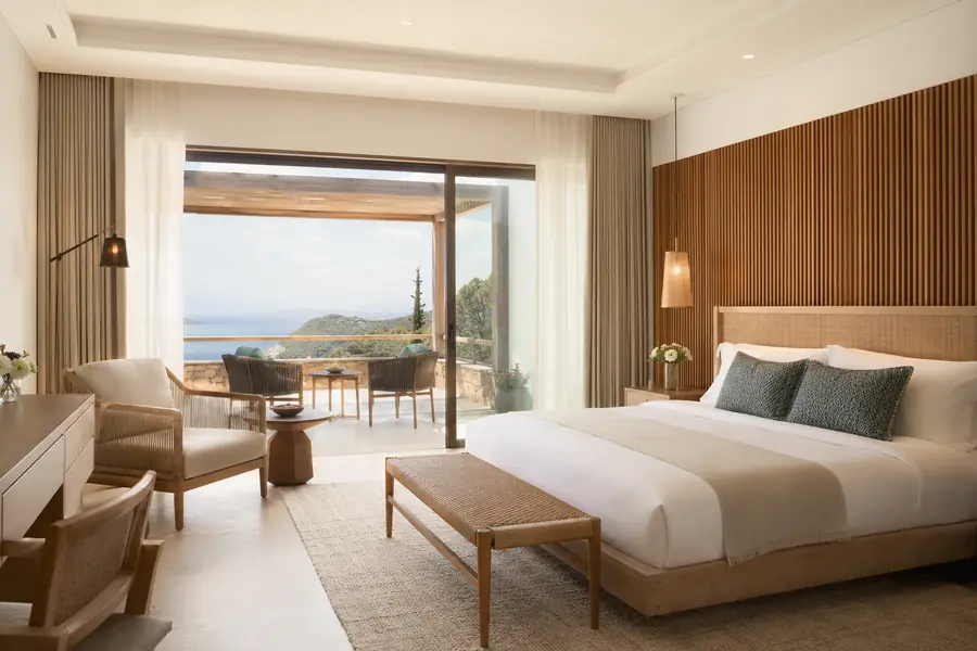 Resort villa bedroom with durable guest-room furniture and a terrace view