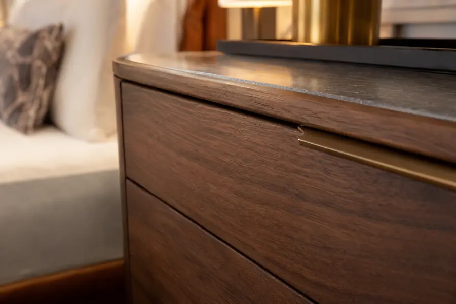 Rounded impact-resistant edge on a hotel dresser