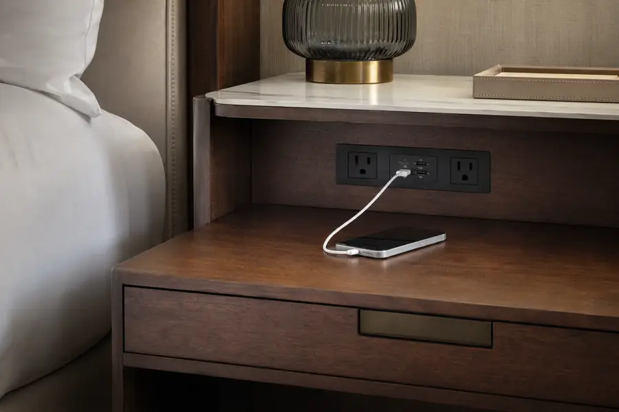 Power and USB charging module integrated into a hotel nightstand