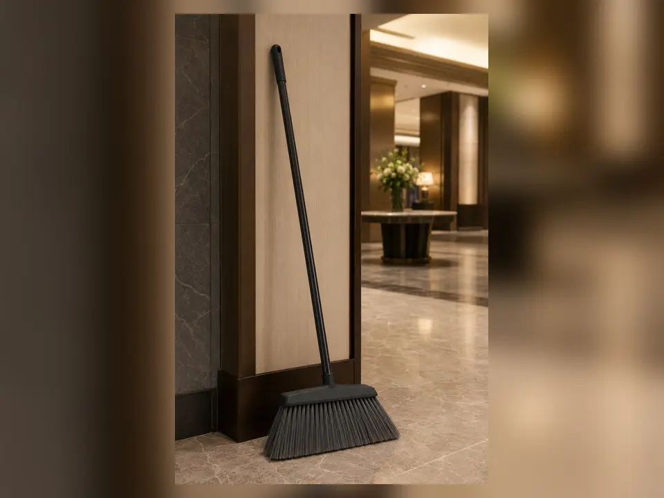 Commercial angled broom in a hotel lobby service alcove