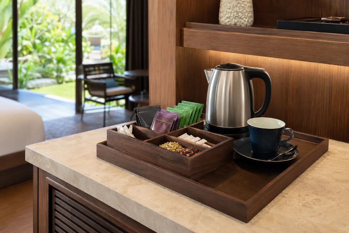 Hotel tea program with kettle, black tea, green tea, herbal infusion, and condiments