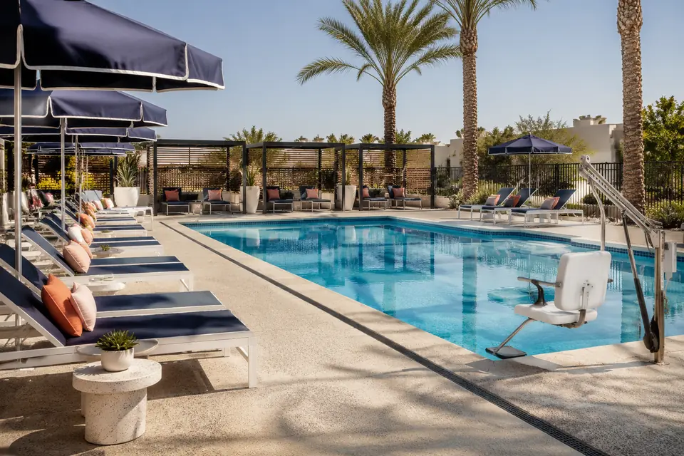 Renovated commercial pool deck with new furniture and accessible lift