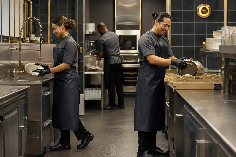 Hotel stewarding team wearing safe practical work uniforms